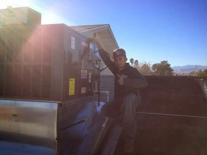 HVAC technician performing Air Duct Repair on a rooftop unit in Chester
